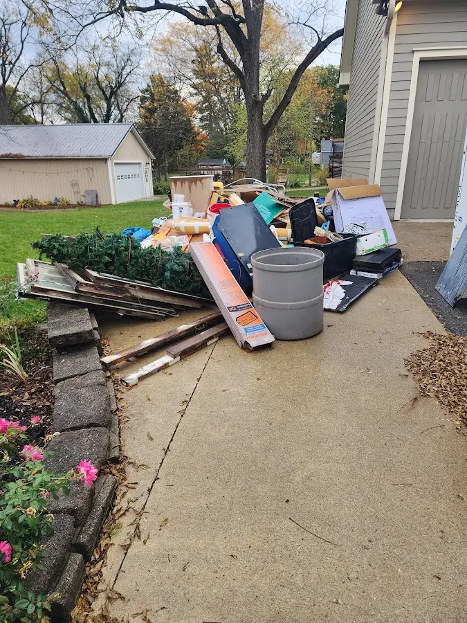 Dumpster being loaded with debris for Estate Cleanout Dumpster Rental in New Albany